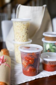 plastic containers filled with food sitting on top of a table