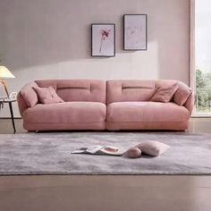 a living room with a pink couch and rug