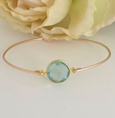 Aquamarine Bead Bracelet -  Aquamarine Bracelet - March Birthstone  A round faceted Aquamarine gemstone will be transformed into an elegant Aquamarine bangle bracelet with a gold filled bangle band. Perfect for a March birthstone bangle bracelet or the something blue for brides on their wedding day.  This March blue aquamarine jewelry can be personalized with an initial charm. Simply add to cart to make a customized aquamarine beaded bracelet; http://www.etsy.com/listing/84670605/add-an-initial- Stackable Round Bracelets For Birthday, Stackable Jewelry For Birthday Gift, Stackable Round Jewelry For Birthday, Adjustable Jewelry With May Birthstone, Adjustable May Birthstone Jewelry With Round Stone, Bangle Jewelry With Bezel Setting For Gift, Elegant Crystal Bracelet For Birthday, Adjustable Gemstone Jewelry For Birthday, Adjustable Gemstone Jewelry For Birthdays