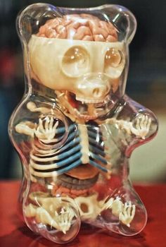 a glass figurine that has been made to look like a bear with its head in the shape of a human body