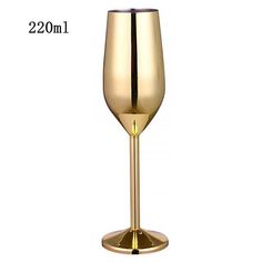 a gold colored wine glass on a white background