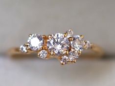 a three stone ring with diamonds on it