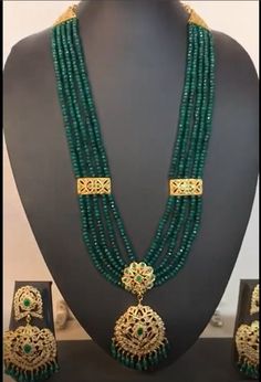 Regal, gold plated rani haar with multiple strings of high quality synthetic emeralds. Perfect choice for Indian, Pakistani and Bangladeshi weddings. The necklace is adjustable by drawstring and falls on the bosom. The Earrings are push-ins and are approximately 3.5 inches in length. Gold Emerald Necklace For Wedding In Temple Style, Gold Emerald Necklace For Wedding Temple Jewelry, Green 22k Gold Jewelry Set For Wedding, Gold Emerald Temple Jewelry Necklace For Wedding, Green 22k Gold Wedding Jewelry Set, Gold Plated Green Jewelry With Latkans, Green Gold-plated Jewelry With Latkans, Green 22k Gold Bridal Necklace For Wedding, Green Emerald Necklace In 22k Gold For Wedding