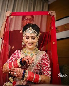 the bride is getting ready to put on her wedding jewelry and make it look like she's about to get married