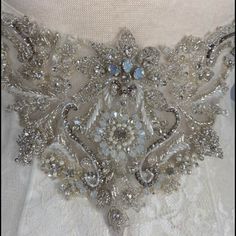 a close up of a dress with beads and sequins on the waistline