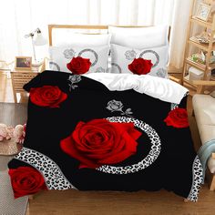 a bed with red roses and leopard print on it