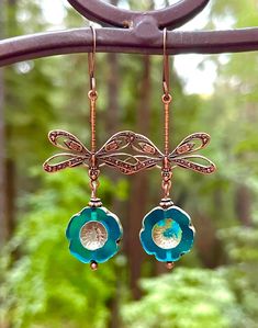 Lightweight copper dragonfly charm earrings with gorgeous aqua blue hibiscus crystal beads.  I spend a lot of time gazing at dragonflies while swimming and sunning at my neighbors pond. Every summer, there are hundreds of dragonflies. I love to watch them chase each other, such elegant creatures. The crystals in this pair were inspired by water drops on the dragonflies as they catch the sun. Adorn yourself with this beautiful and very lightweight pair of dragonfly earrings.   2 inches long. Wing Nickel-free Blue Dragonfly Jewelry, Copper Dangle Crystal Earrings For Gift, Blue Hypoallergenic Copper Earrings, Creative Earrings, Earring Inspo, Dragonfly Gifts, Blue Hibiscus, Earrings Nature, Dragonfly Jewelry