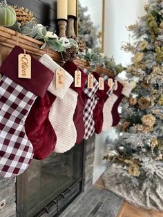 stockings hanging from a mantle with christmas decorations