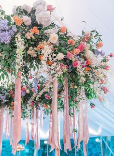 an arrangement of flowers hanging from the ceiling