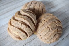 three cookies sitting on top of a wooden table