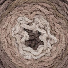 a close up view of the center of a pile of rugs that have been rolled together