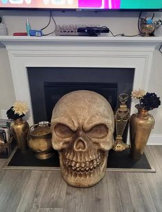 a fake skull sitting in front of a fireplace