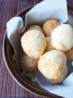 some food that is in a bowl on a wooden table with napkins and paper