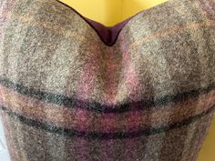 the back of a woman's dress with a plaid pattern