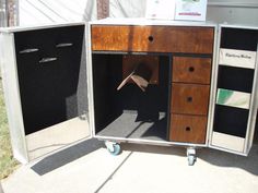 an open cabinet with drawers and wheels on the outside