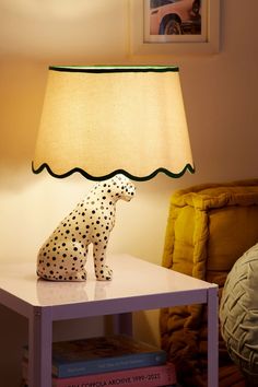 a lamp that has a dalmatian figurine sitting on top of it