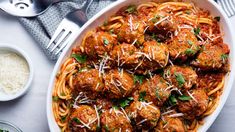 meatballs and spaghetti in a bowl with parmesan cheese