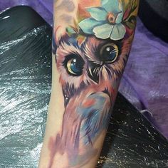 an owl with flowers on it's head is shown in this tattoo art photo