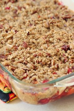 a casserole dish filled with oatmeal and cranberry topping