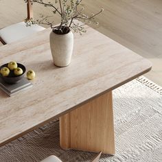 a table with some fruit on it and a vase full of flowers next to it