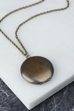 Dark finish brass locket necklace with sleek and simple design. This wonderful round vintage locket has a slight but beautiful wear reflecting decades of use. Great to wear on its own or in a layered look. Ready for your pictures! D E T A I L S : •Photo #1, 5, 6 & 7: 28 length •Photo #3: 26 Classic Locket Necklace With Adjustable Chain, Metal Oval Pendant Locket Necklace, Metal Oval Locket Necklace, Classic Locket Necklace With Round Pendant And Adjustable Chain, Classic Antique Gold Locket Necklace, Classic Brass Locket Necklace With Vintage Charm, Brass Medallion Locket Necklace With Adjustable Chain, Classic Brass Medallion Locket Necklace, Brass Pendant Locket Necklace With Adjustable Chain