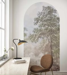 a chair sitting in front of a wall mural