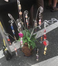 a basket filled with lots of beads next to a pole