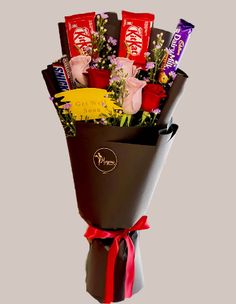 a bouquet of chocolates and flowers in a vase