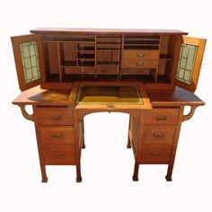 an antique desk with two drawers and a cabinet on the top, open to reveal its contents