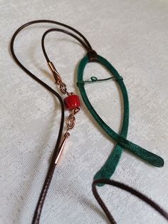 a pair of scissors are laying on the table next to some cords that have been tied together