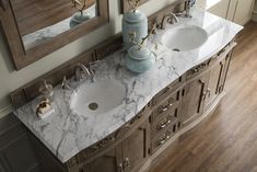 two sinks and mirrors in a bathroom with wood flooring next to eachother