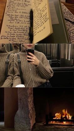 a woman is holding an open book in front of a fire place with writing on it