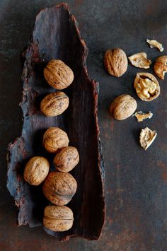 walnuts and other nuts on a piece of wood