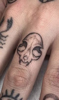 two fingers with tattoos on them