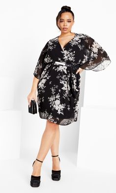 Feel fabulously flourishing in the Bouquet Mini Dress! Boasting flared elbow-length sheer sleeves and a plunging V-neckline, this fully lined mini dress hugs your curves in a gorgeously dreamy style. Key Features Include: - Plunging V-neckline - Flared elbow-length sheer sleeves - Removable gold buckle waist belt - Elasticated back for a fitted waist - All over sheer overlay with gathered sides - Fully lined - Pull over style Complete your style with drop diamante earrings and stilettos. | Plus Plus Size Short Dresses, Dreamy Style, Diamante Earrings, Knitwear Style, Mini Bouquet, City Chic Dresses, Plus Size Cocktail Dresses, Sheer Overlay, Plus Size Fashion For Women