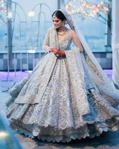 a woman in a white and silver wedding gown