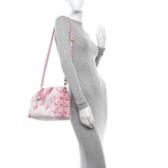 This is an authentic LOUIS VUITTON Monogram Giant By The Pool 2.0 Speedy Bandouliere 25 in Rose. This limited edition speedy features an oversized version of the classic Louis Vuitton monogram print on white and pink toile-coated canvas. The bag has pink and white monogram rolled leather top handles, an optional adjustable shoulder strap, and brass hardware. The top opens to a pink printed fabric interior with a zipper pocket. Speedy Bandouliere 25, Speedy Bandouliere, Monogram Prints, Printed Fabric, Brass Hardware, The Pool, Authentic Louis Vuitton, Leather Top, Pink And White