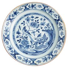 a blue and white plate with an image of a bird in the middle of it