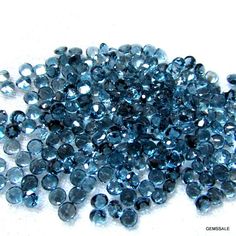 some very pretty blue beads on a white surface