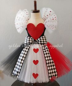 a dress made out of tulle and fabric with hearts on the front, attached to a mannequin