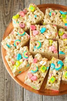 some rice krispy treats are on a plate with sprinkles and candy