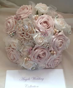 a bridal bouquet with pink roses and pearls