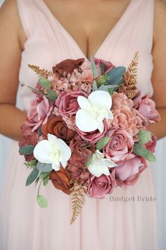 a woman in a pink dress holding a bridal bouquet with flowers on the side