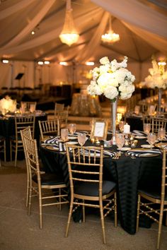 an image of a table set up for a wedding reception with flowers in the center