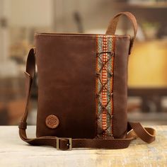 "Using traditional techniques, the artisan crafts a sling from brown leather, equipping it with an adjustable strap, a zipper closure, and a cotton lining. As a final touch, adds a colorful wool textile at the front as an homage to her heritage. 0.8 lbs Bag: 9\" H x 7.75\" W x 1.2\" D Strap(s): 48\" min L - x 55\" max L x 0.8\" W Drop length: 22.5\" min L - x 26\" max L Leather, wool fabric; cotton lining Features a zipper closure Adjustable strap(s) Hand-crafted item -- color, size and/or motif Bridesmaid Gift Bags, Bridesmaid Bags, Woman Bag, Leather Crafts, Handbag Leather, Leather Handbags Crossbody, Leather Cleaning, Final Touch, Wool Fabric