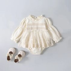 Cream Cotton Bubble Romper With Short Sleeves, Cream Fitted Bubble Romper With Ruffles, Fitted Cream Bubble Romper With Ruffles, Cute Cream Bubble Romper With Ruffles, Solid Cotton Bodysuit With Ruffles, Spring Bubble Romper With Puff Sleeves And Ruffles, Spring White Ruffled Onesie, Solid Color Onesie With Ruffles For Spring, Spring Onesie With Ruffles In Solid Color