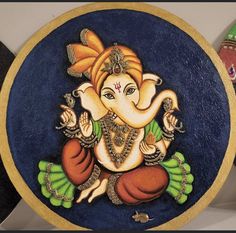 an elephant painted on the side of a blue plate with gold trim and green accents