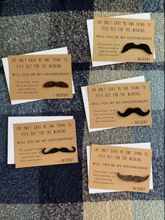 four pieces of paper with fake moustaches on them