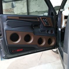 the interior of a vehicle with its door open and speakers in place to be installed