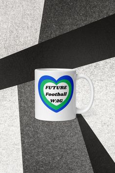 a white coffee mug with the words future football w / c on it's side